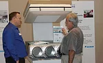 Robert Powell (left), VRV application engineering manager, Daikin North America, explains the benefits of Daikin's VRV products to a sales meeting attendee.