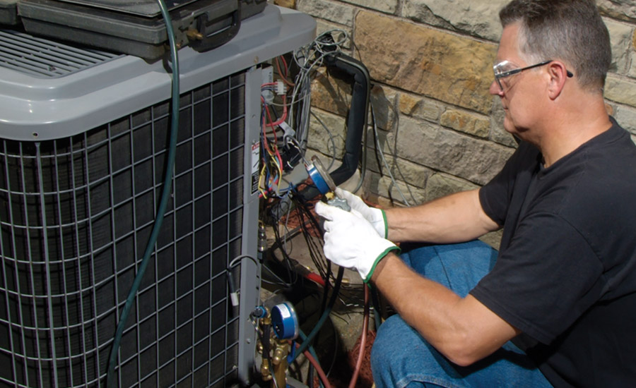 An HVAC technician retrofits a residential air conditioning unit from R-22 to FreonÃ¢âÂ¢ MO99. Photo courtesy of the Chemours Co.