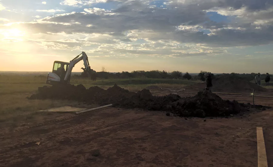 Carrier dealer B and L Heating and Air Conditioning in Stillwater, Oklahoma, digs to install the coils for a geothermal heating and cooling system. PHOTO COURTESY OF CARRIER CORP.