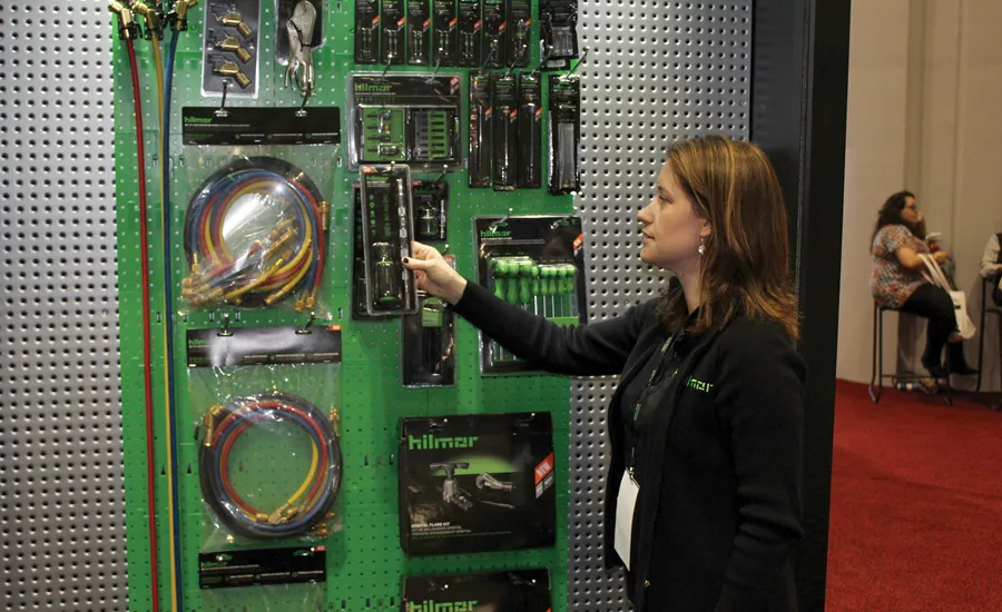 Emily Bavaro, director of marketing, Hilmor, looks over some of the company’s newest tools on display at the AHR Expo.