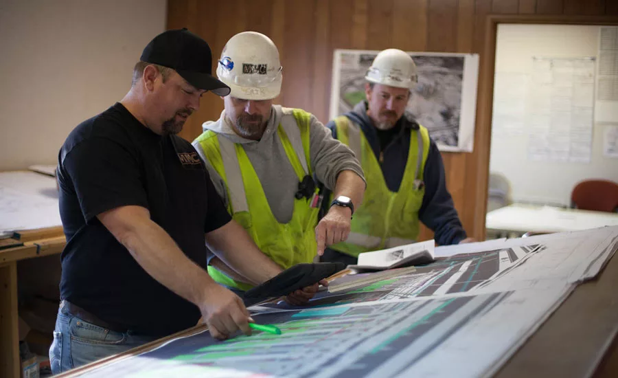 Walt Thompson (left), pipefitter foreman at Metropolitan Mechanical Contractors (MMC), Eden Prairie, Minnesota, discusses plans with MMC plumbers Erik Torgerson (middle) and Jase Holden (right).