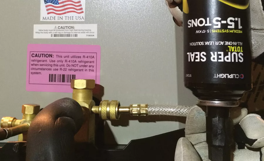 A tech installs Cliplight’s Super Seal Total into a system. Photo courtesy of Cliplight Manufacturing