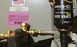 A tech installs Cliplight’s Super Seal Total into a system. Photo courtesy of Cliplight Manufacturing
