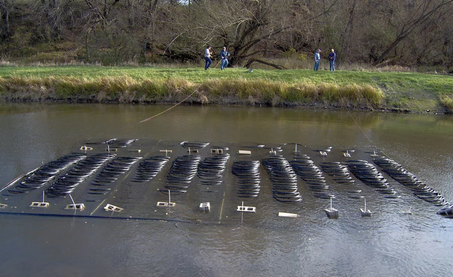 A 12-ton pond loop heat exchanger system is sunk to the bottom of a pond for use in a heat pump installation.
