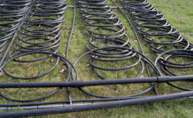 A 12-ton heat pump system is laid out prior to being sunk into a pond. PHOTO COURTESY OF MARK JOHNSON, HTTP://BIT.LY/MARKJOHNSONGEOTHERMAL2