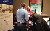Joann Donelon, director of marketing, White-Rodgers, talks with contractors during the trade show portion of the International Roundtable meeting.