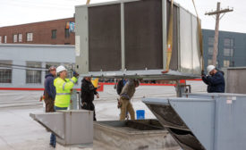 A Modine Atherion unit is lowered onto a roof curb atop North Market in Columbus, Ohio.