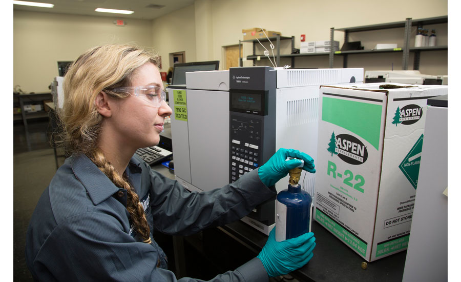 Chemist Danielle Creel prepares to connect a sample bottle of refrigerant gas to a mass spectrometer