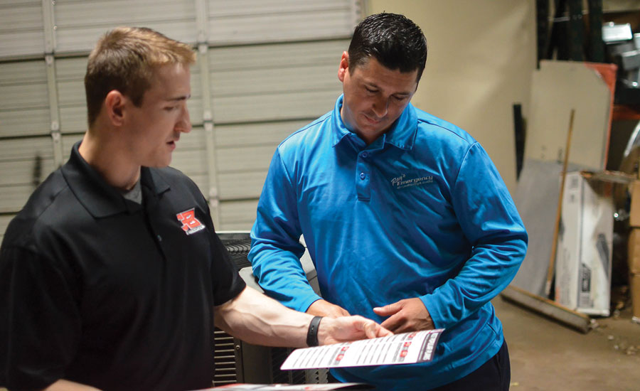 Bobby Gillespie (left), inside sales, JB & Associates, discusses extended warranty options with Roland LeTeff (right) of Ray’s Emergency Air, Dallas. PHOTO COURTESY OF JB & ASSOCIATES.