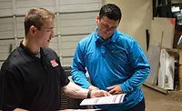 Bobby Gillespie (left), inside sales, JB & Associates, discusses extended warranty options with Roland LeTeff (right) of Ray’s Emergency Air, Dallas. PHOTO COURTESY OF JB & ASSOCIATES.