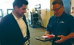 Mike Montano (left), founder of ReviewBuzz, talks with Brian Redman, Koch Air.