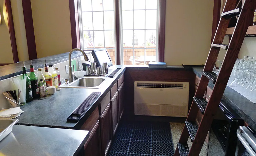 VRF systems offer great flexibility for delivery of heating and cooling comfort. Here, a Fujitsu General America Inc. floor/ceiling unit provides comfort for a separate work zone – a lofty bar with high, afternoon solar gain.