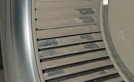 Dirt and drywall dust cover the blower wheel of a brand new HVAC system in a newly constructed home. Photo courtesy of Building Performance Group