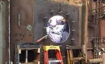 workers weld on a burner plate