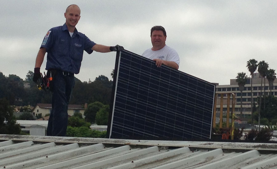 Richard Hiteshew (right), owner, A-1, and Matt Hiteshew (left), his son, work together to install solar panels - ACHR