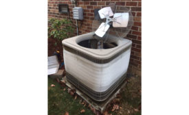 An air-source heat pump with a severely frosted outdoor evaporator coil.  - ACHR