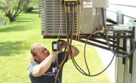Steven Janssen, lead installer at Budget Heating, Cooling & Plumbing in St. Peters, Missouri, installs a new system for a homeowner. - ACHR