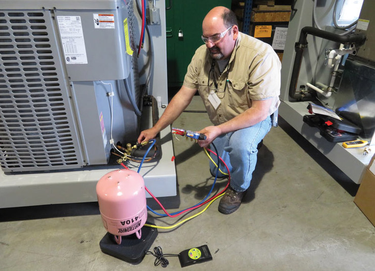 UA instructor Philip Roknich, from Local 130 in Chicago, demonstrates how to properly charge a system. - The ACHR News