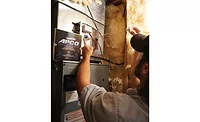 Hagerstown Heating and Cooling 01 Collin Poyle, a technician at Hagerstown Heating and Cooling, installs a UV lamp. - The ACHR News