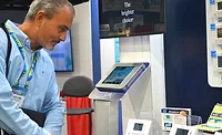 Braeburn-Thermostat-AHR-Expo-2019-ACHR-News-01.jpg A visitor at the Braeburn booth stops to admire the simplicity of the company’s smart thermostat offerings. - The ACHR News