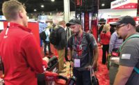 Keefer Rader, owner of Outlaw Mechnical in Sandia Park, New Mexico, and Gabriel Curry, a service tech at the company, checked out Milwuakee Tools&rsquo; battery-powered pipe threader. - AHR Expo 2019 - The ACHR News