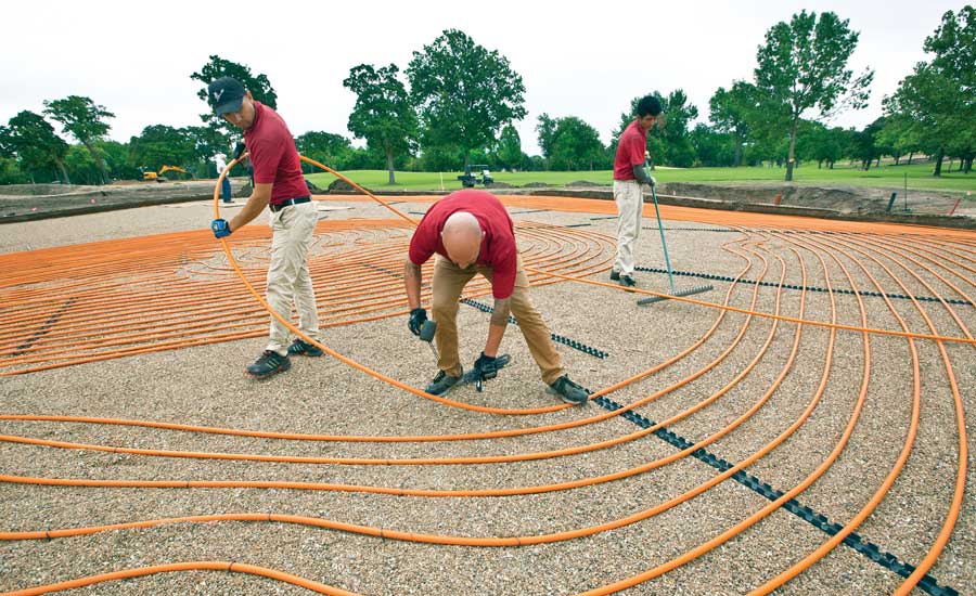 SHCC grounds crew members (left to right) Oscar Mendez,
Matthew Jackson, and Edwin Gomez lay Watts RadiantPERT tubing on what
will become a green surface. - The ACHR News