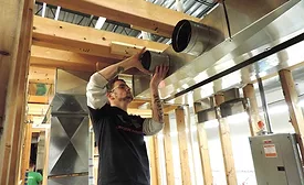 A student at the training center for SMART Local 265 in Carol Stream, Illinois, practices duct installation.