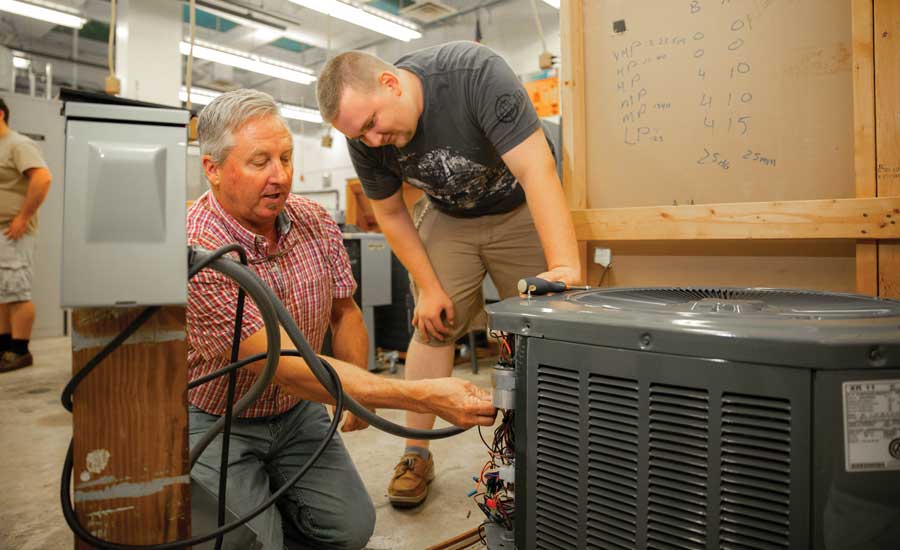 An instructor shares some instruction in the HVAC apprentice program at Santa Fe College.