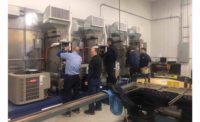 Employees at Chapman Heating and Cooling get a look at the latest products the company offers.