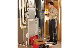 A technician installs an Emerson Sensi Predict.