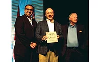 ACHR NEWS editorial director Kyle Gargaro (at left) and Ron Smith (at right) present The ACHR NEWS’ Ron Smith Leadership Award to Jim Batson, owner and CEO of H.C. Blake Co.