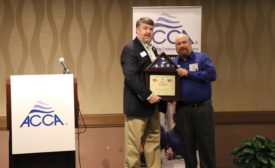 ACCA President and CEO Barton James presents 2019 Service Manager of the Year Craig Sabol with an American flag.