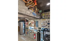 Plywood walls covered in a very convincingly poured concrete mural containing the HVAC system.