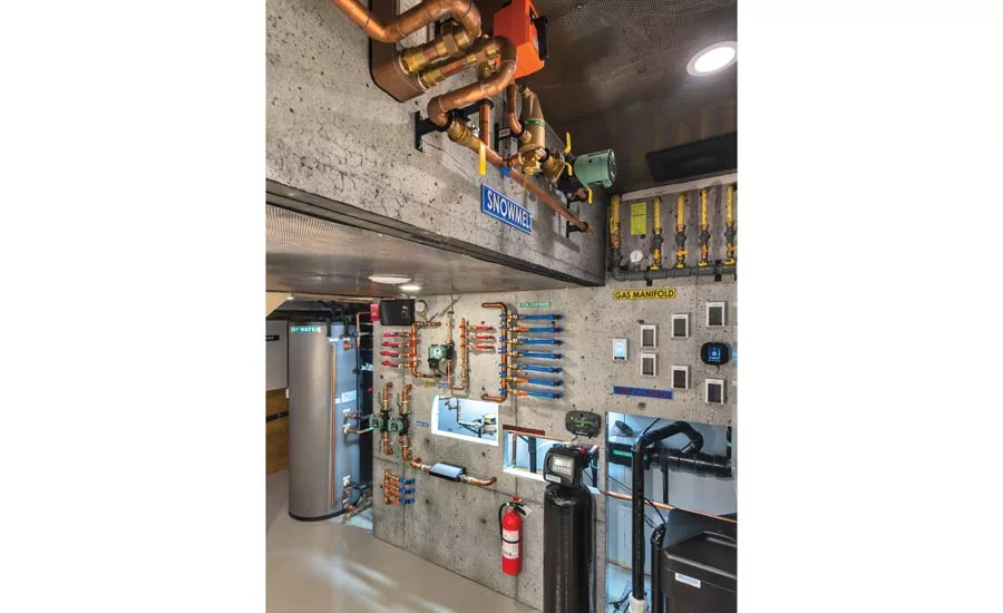 Plywood walls covered in a very convincingly poured concrete mural containing the HVAC system.