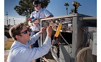 Dan Veatch (in hat), senior HVAC technician, and Jacob Pelto, HVAC service apprentice, from Forrest Anderson Plumbing & Air Conditioning Inc., work on a rooftop unit.