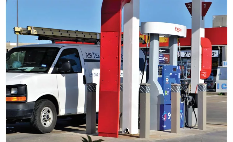 Service vehicle filling up at gas station.