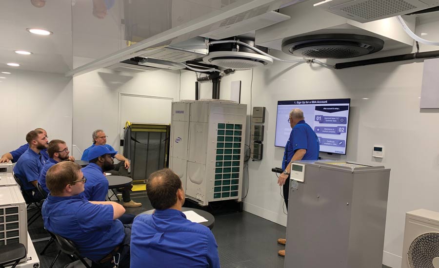 Staff at Joseph Giaonne Plumbing, Heating and Air Conditioning watch a training video.