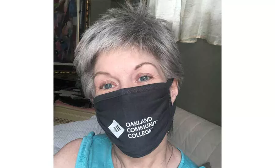 Kathryn sports her new official “work” mask from Oakland Community College.