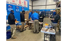 Masked staff at Infinity Texas Air  fix their plates during the firm's Thanksgiving lunch.