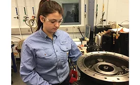 A student assesses the compressor equipment on a job site.