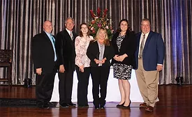 Travis Seeger, far left, and Chris Seeger, far right, join members of their team in accepting the Torch Award from the St. Louis Better Business Bureau.