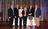 Travis Seeger, far left, and Chris Seeger, far right, join members of their team in accepting the Torch Award from the St. Louis Better Business Bureau.