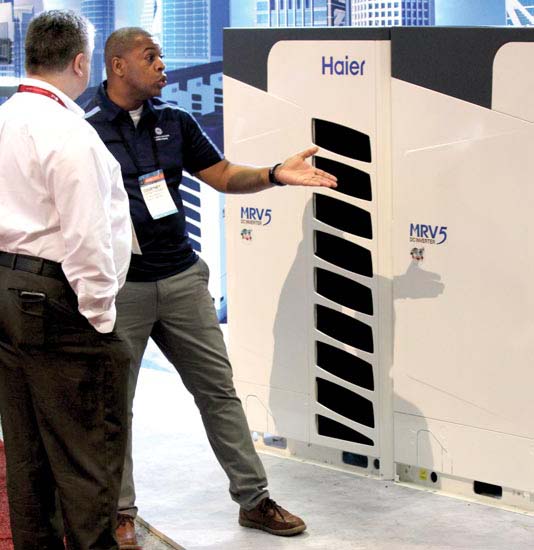 Gardner explains the features of the MRV-5 series to a booth visitor.