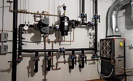 A geothermal mechanical room displays a selection of geothermal technology for contractors to learn, understand, and convey the benefits of to their customers.