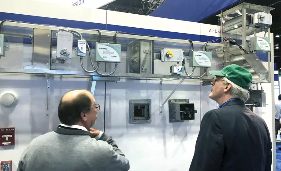 A Ruskin employee shows an attendee the finer points of the ADC105 addressable damper controller.