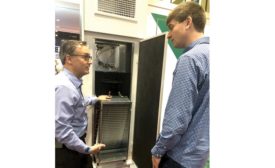 Tony Landers, vice president of sales and marketing, The Whalen Company, shows an attendee how the slide-out coil pack allows for simplified service and maintenance.