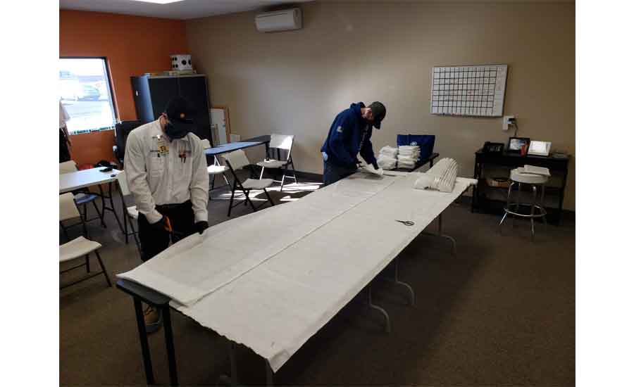 Staff at Comfort Matters Heating and Cooling in Hanover, Minnesota, make masks out of extra air filters.