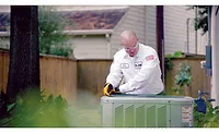 One-Hour-Technician.jpg A One Hour technician works on a customer’s air conditioning.