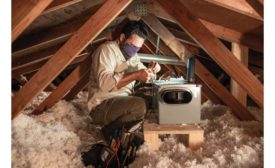 A tech installs an Aprilaire unit in an attic.