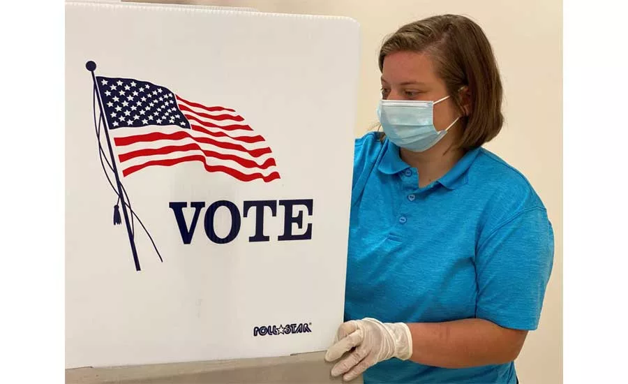 An ROTC Cadet sanitizes a voting station in Lawrenceburg, Kentucky.